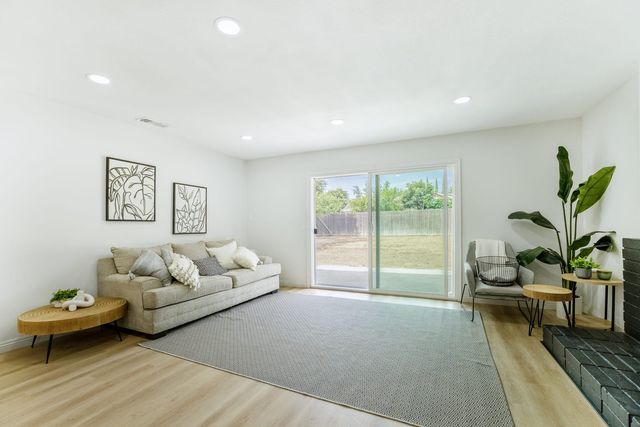 Living room with a sofa, a brick hearth and a sliding door to the back yard